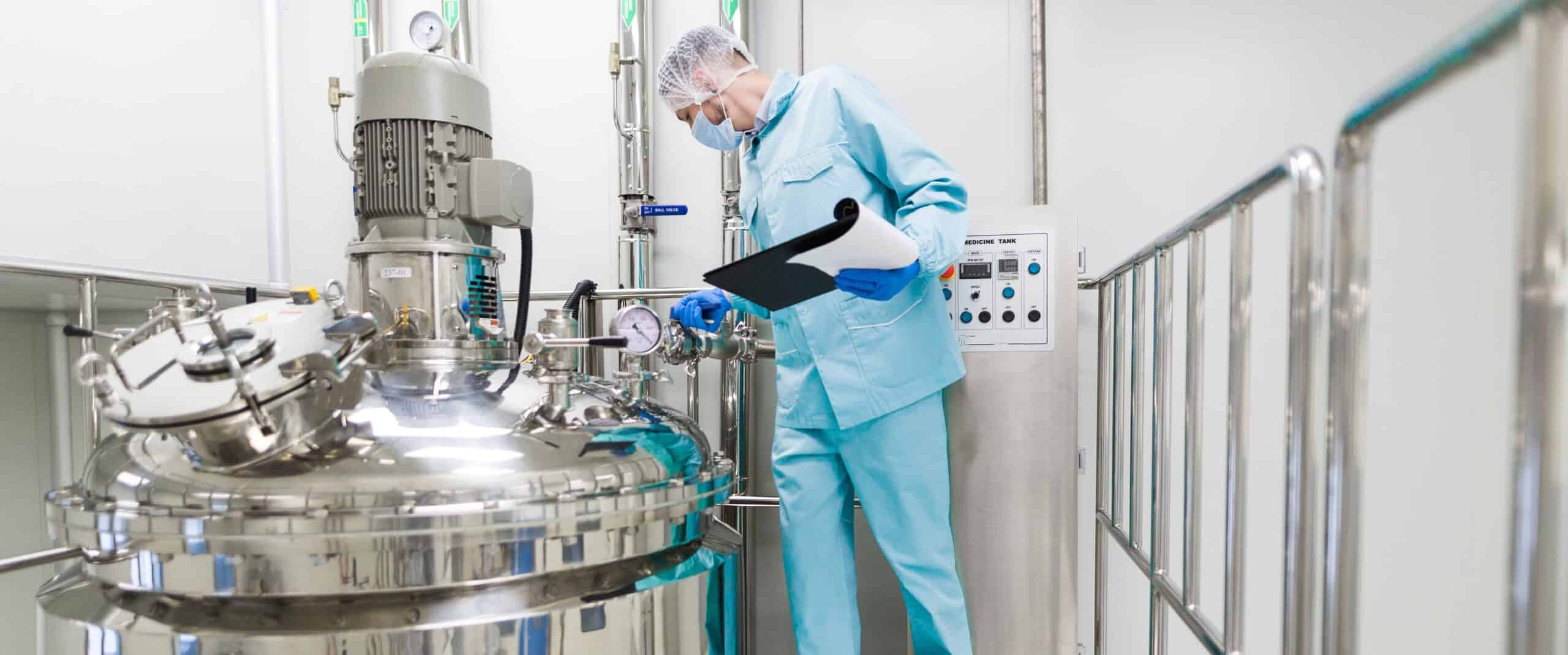 scientist-blue-lab-suit-working-with-control-panel-look-camera-scaled-cropped